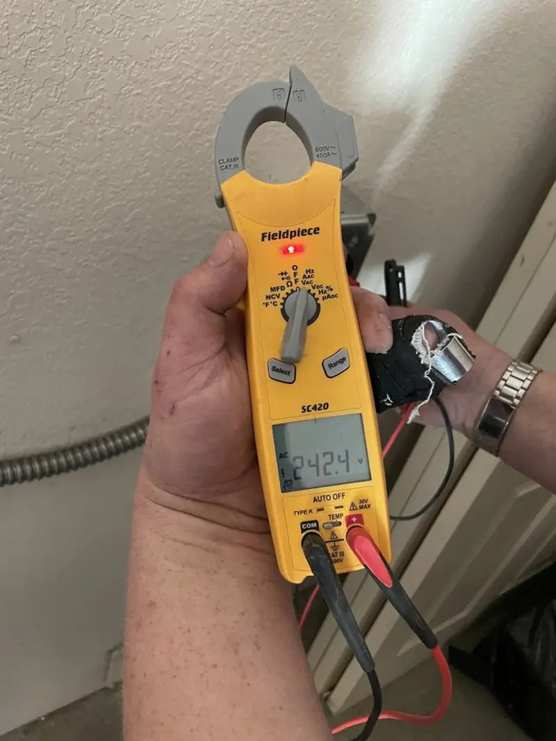 Voltage testing with clamp meter during Outlet Installation in Union Mill